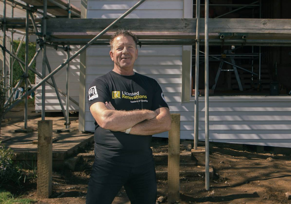 Russell Clark, renovation expert, smiling on-site during a home renovation.