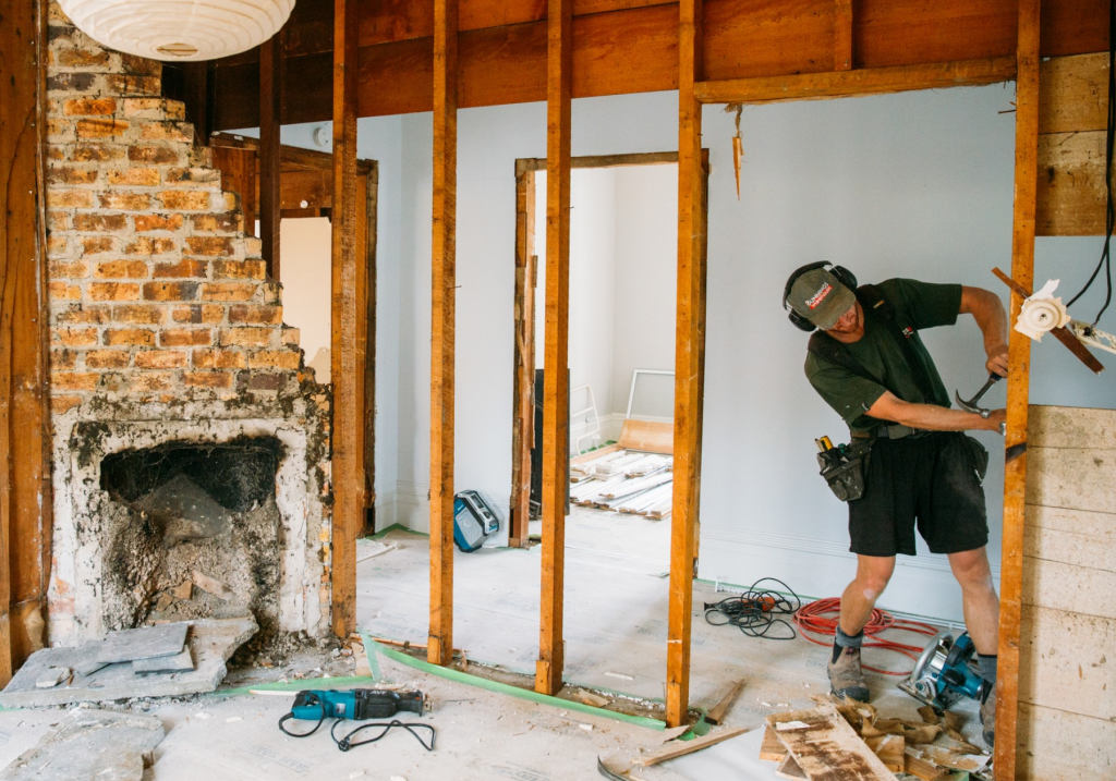Builder explaining renovation details to homeowners with timber samples.