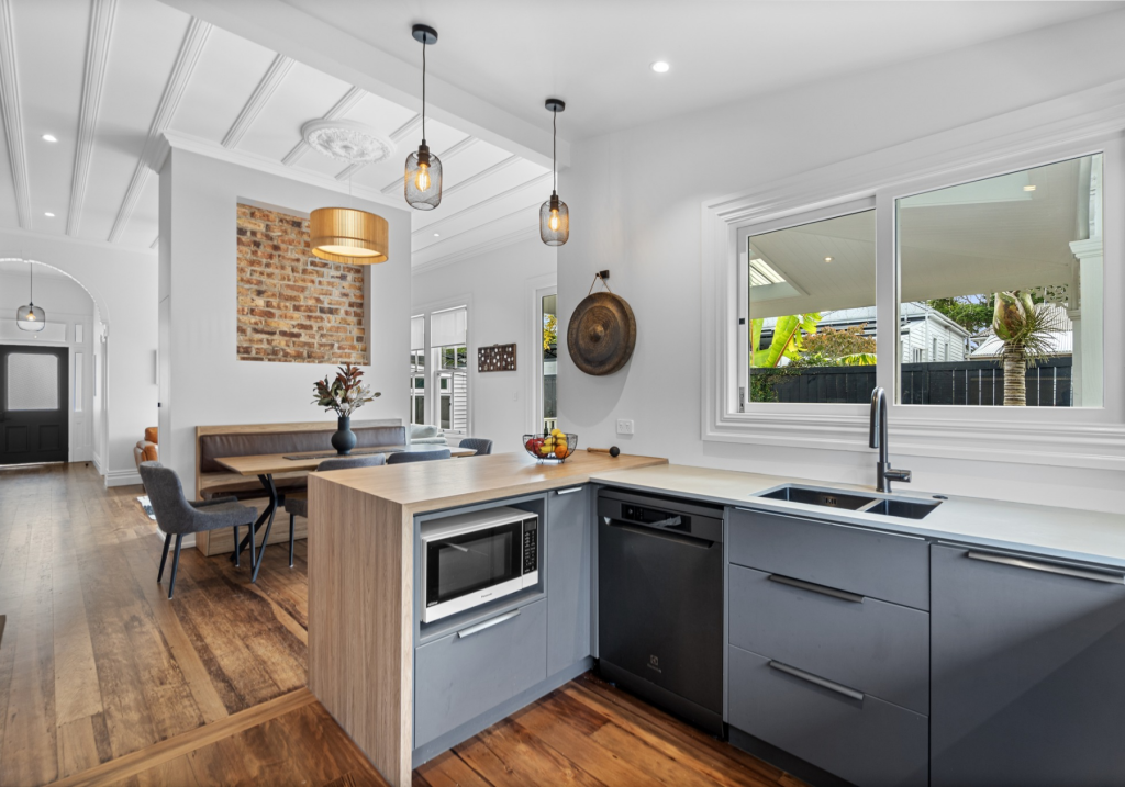 Contemporary open-plan kitchen and lounge leading out to deck.