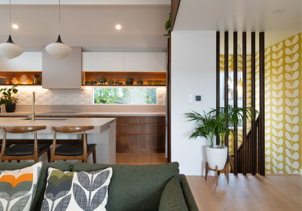 Modern open-plan living room with wooden finishes, indoor plants, and natural light